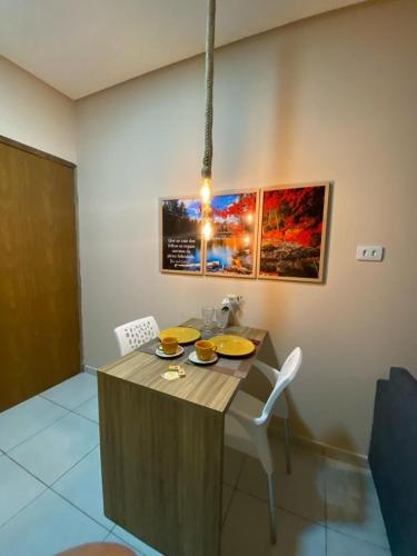 a kitchen with a table with yellow plates on it at zaiflats outono in Vitória de Santo Antão