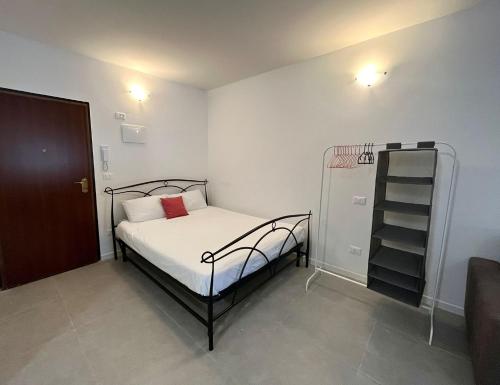 a small bedroom with a bed and a book shelf at Arcadia Hosting Aeroporto in Bologna