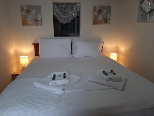 a bed with two towels with hello kitty towels at Seafront Villa, Fay in Kardamyli