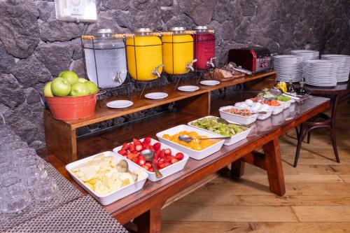 a table with many plates of food on it at Wyndham Puerto Varas Pettra in Puerto Varas