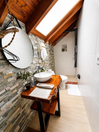 a bathroom with a sink and a mirror at Hotel Casa Madero in Envigado