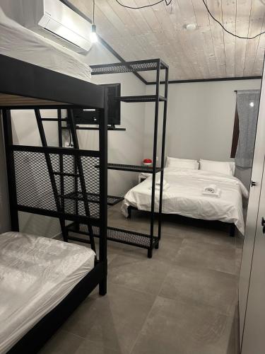two bunk beds in a room with two beds at Letsios Steel3 in Kalabaka