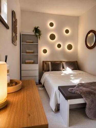 a bedroom with a bed and a table and a mirror at Wellspace Forest Retreat in Karlovy Vary