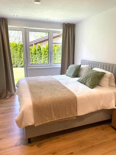 a large bed in a bedroom with a window at Apart Alma in Pfunds