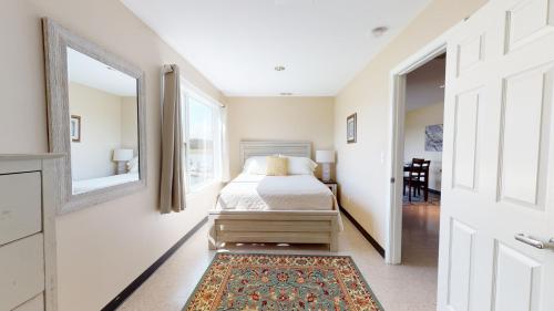 a bedroom with a bed and a mirror at Surry Seafood Company in Surry