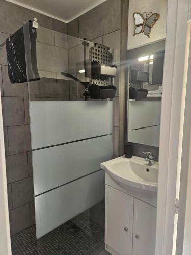 a white bathroom with a sink and a mirror at Moriani Plage San-Nicolao Les Marines de Moriani in San-Nicolao