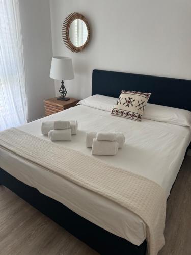 a large bed with white sheets and pillows on it at Luxury Villa Mariachiara in Monopoli