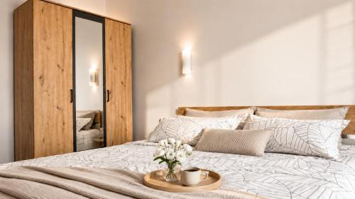 a bedroom with a bed with a tray with flowers on it at Center Vibes Lux in Rijeka