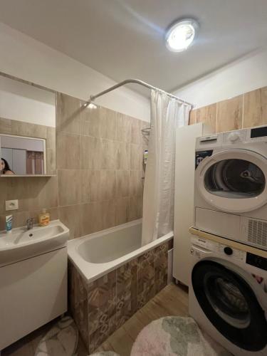 a bathroom with a washing machine and a washer at Exnárova in Prievoz