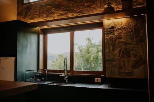 a kitchen with a sink and a window at Villa Arouca in Areal