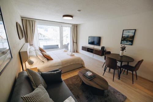 a hotel room with a bed and a table at Apartment in Engelberg in Engelberg