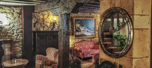 a room with a mirror and two chairs in it at Hotel Altamira in Santillana del Mar
