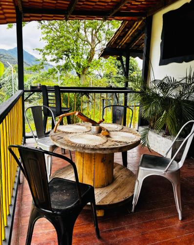 a patio with a table and chairs on a deck at Casa Atelier AXM in Salento