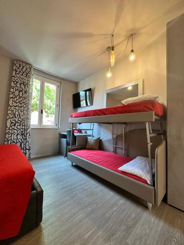 a room with two bunk beds and a television at Residenza Nonno Mella in Porto SantʼElpidio