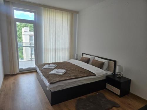 a bedroom with a large bed and a large window at Artea Hisarya in Hisarya