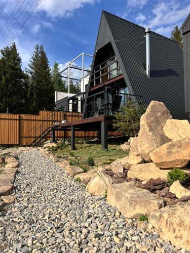 a house with a balcony and some rocks at Diamond chalet A-frame in Ogrody