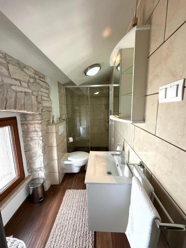 a bathroom with a white sink and a toilet at Tea Rooms III in Bale