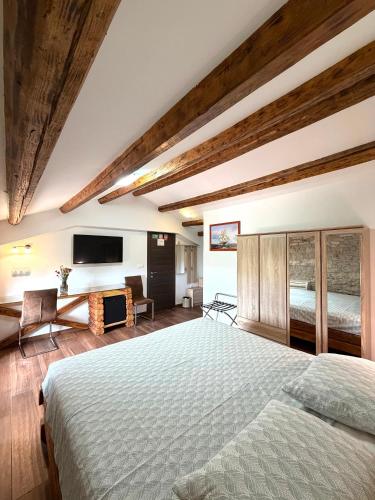 a bedroom with a large bed and a television at Tea Rooms III in Bale