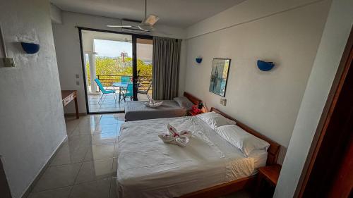 a bedroom with a bed with a bow on it at Samara Ocean View in Sámara