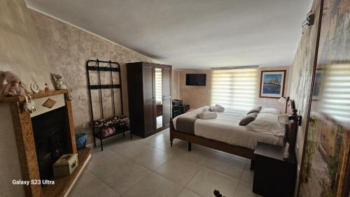 a bedroom with a bed and a fireplace at Torre Serena B&B in Atella