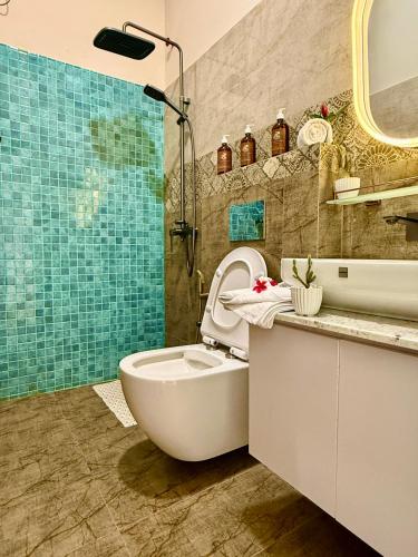 a bathroom with a toilet and a sink and a shower at Hotel Beach Castle in Arugam Bay