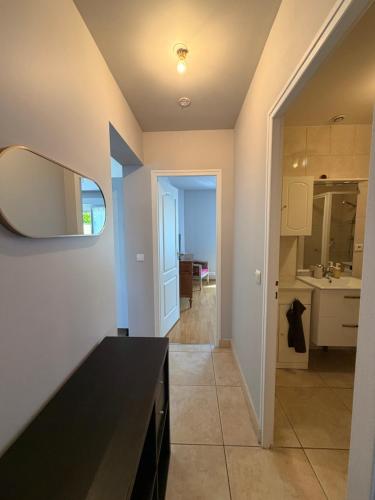 a kitchen with a black counter and a mirror at Magnolia58 in Pontault-Combault