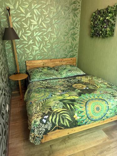 a bedroom with a bed with a colorful comforter at Appartment im Villenviertel in Jena