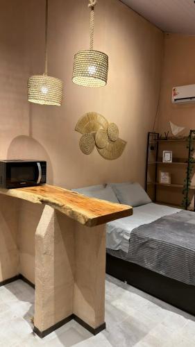 a room with a table and two lamps and a bed at Guajiru Beach House KiteSurf in Trairi