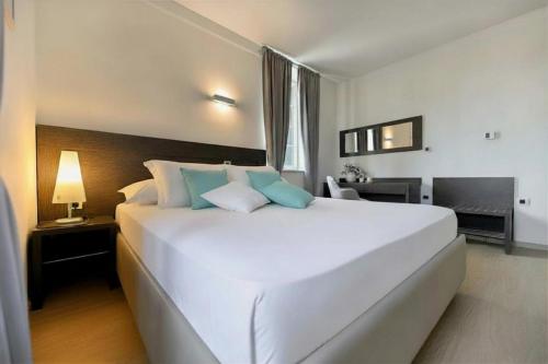 a large white bed in a hotel room at Villa Hrešć I in Zadar