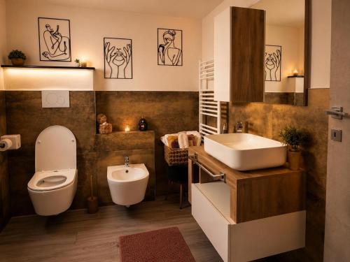 a bathroom with a sink and a toilet and a sink at Umbertos Rooms in Jerzu
