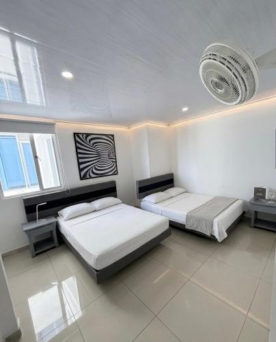 two beds in a room with two windows at Luxury Suite with Pool in Melgar in Melgar