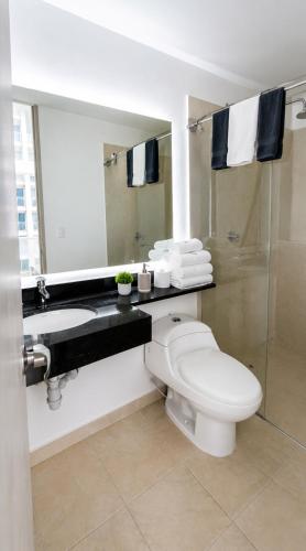 a bathroom with a toilet and a sink and a mirror at Luxury Suite with Pool in Melgar in Melgar