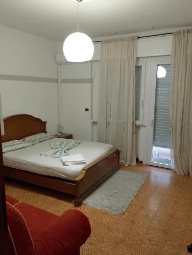 a bedroom with a bed and a large window at Ampia camera con balcone privato in Pordenone