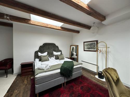 a bedroom with a large bed in a room at Liselund Ny Slot Hotel in Borre