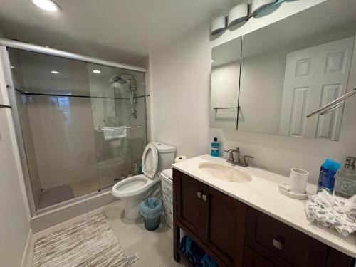 a bathroom with a shower and a toilet and a sink at Condominium Sunny Isles Ocean Reserve in Sunny Isles Beach