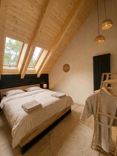 a bedroom with a large bed in a attic at Cabana Crang in Dobra
