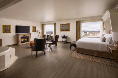a hotel room with a bed and a fireplace at The Davenport Tower, Autograph Collection in Spokane