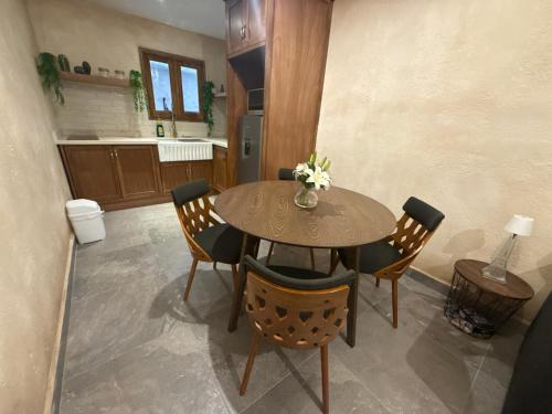 a dining room with a wooden table and chairs at Loft Elena en ValQuirico in Santeagueda
