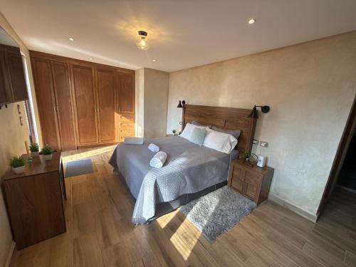 a bedroom with a large bed and wooden floors at Loft Elena en ValQuirico in Santeagueda