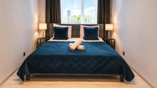 a bedroom with a bed with a teddy bear on it at Centrum Warszawy - City Center the best places, metro Centrum & Świętokrzyska, partial view of the Palace of Culture, self check-in, AC, optional breakfest in Warsaw
