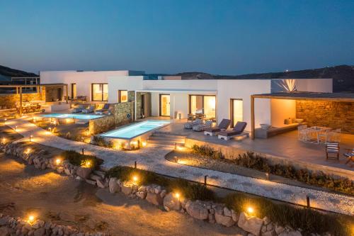 a villa with a swimming pool at night at Villa Nabia by Milos Concierge in Adamantas