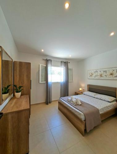 a bedroom with a large bed in a room at Villa Eleni Apartment no3 in Agios Gordios