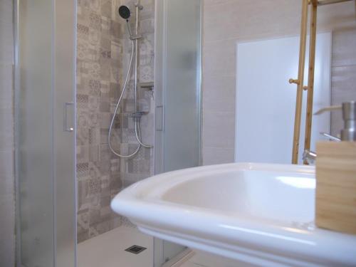 a white bathroom with a sink and a shower at Chicche di Lavanda in Valmadonna