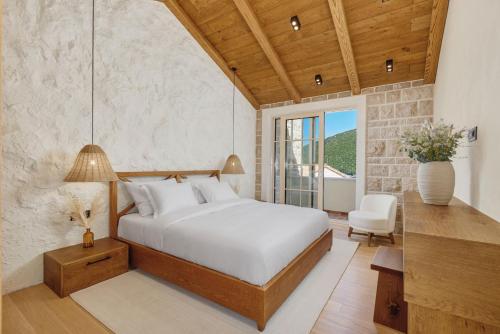 a bedroom with a bed and a table and a chair at MiraMare in Luštica