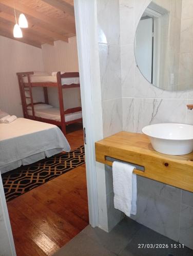 a bathroom with a sink and a mirror at Alojamiento mei-mei in Puerto Iguazú