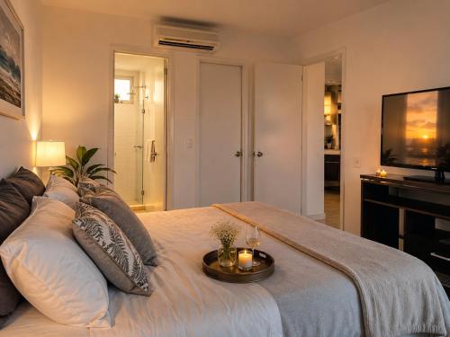 a bedroom with a large bed and a television at Morros 3 Frente al Mar - Piscinas y Jacuzzi in Cartagena de Indias