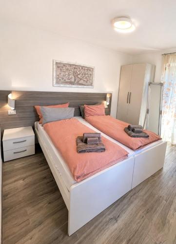 a bedroom with a large bed with orange sheets at Casa Guerines in Tremosine Sul Garda