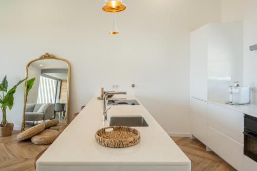 a kitchen counter with a sink and a mirror at Villa Aurora Luxury Villa with Infinity Pool in Portimão
