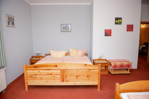a bedroom with a wooden bed in a room at Aparthaus Schmiedeschenke in Dresden