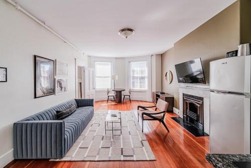 a living room with a couch and a fireplace at Beacon Hill Nights in Boston